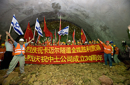 פועלים סינים וישראלים חוגגים את סיום העבודות בפרויקט מנהרות הכרמל