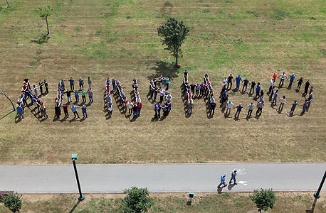 Kenshoo's team spell out their company's name. Photo: Amit Shaal