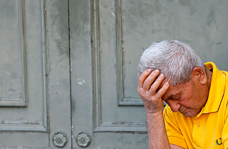 קשישי יווני באתונה ממתין לקבל חלק מהפנסיה שלו, צילום: רויטרס