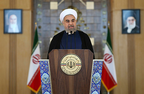 נשיא איראן חסן רוחאני אחרי החתימה על ההסכם