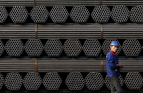עובד במפעל צינורות בסין. יחס החוב-תוצר של המדינה זינק לשיא, צילום: רויטרס