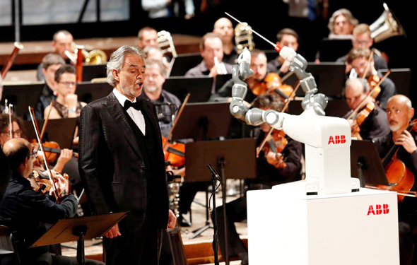 הרובוט יומי מנצח על התזמורת לצד זמר הטנור אנדריאה בוצ'לי
