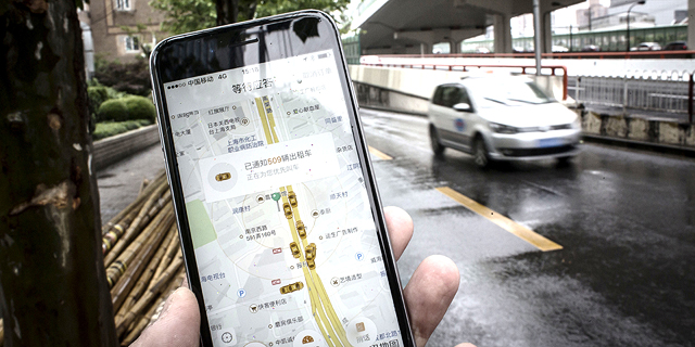 אפליקציית הזמנת הנסיעות דידי צ‘ושינג. אלפי משתמשים שיתפו תמונות שלהם מוחקים אותה מהטלפון, צילום: בלומברג