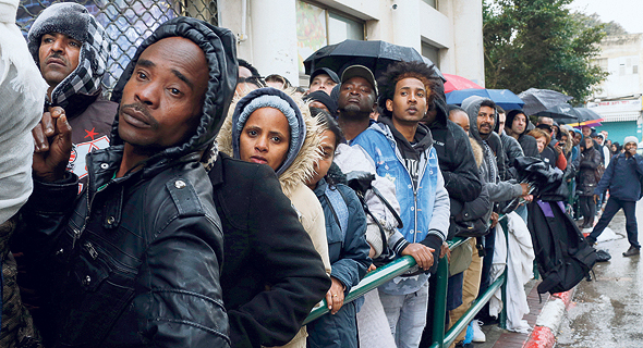 A line of asylum seekers formed outside a government office in Tel Aviv. Photo: Amit Shaal