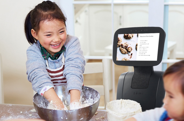 Temi helps children bake cookies. Photo: PR