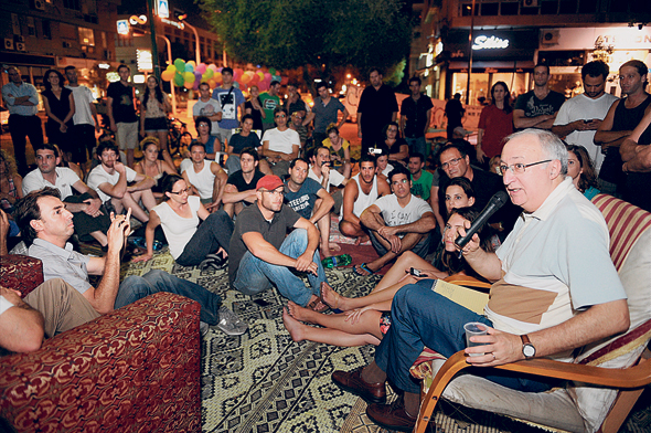 פרופ' מנואל טרכטנברג בשיחה עם מפגינים בכיכר המדינה בתל אביב, צילום: יובל חן