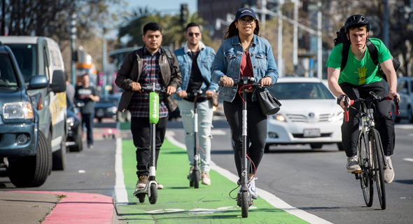 People riding electric scooters in San Francisco. Photo: Bloomberg