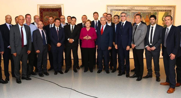 Angela Merkel and men. Photo: Facebook