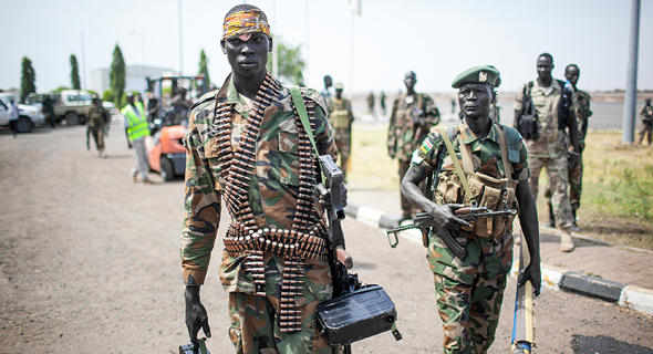 South Sudan is known for its blatant human rights violations and strict military control, an armed soldier walks past (pictured). Photo: Shutterstock
