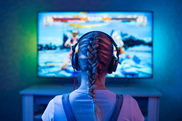 A girl playing a video game. Photo: Shutterstock