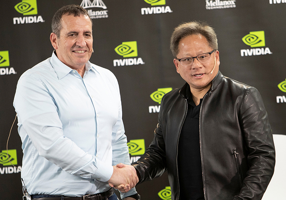 Eyal Waldman, founder and CEO of Mellanox shakes hands with Jensen Huang (right), founder and CEO of NVIDIA. Photo: Gil Nehushtan