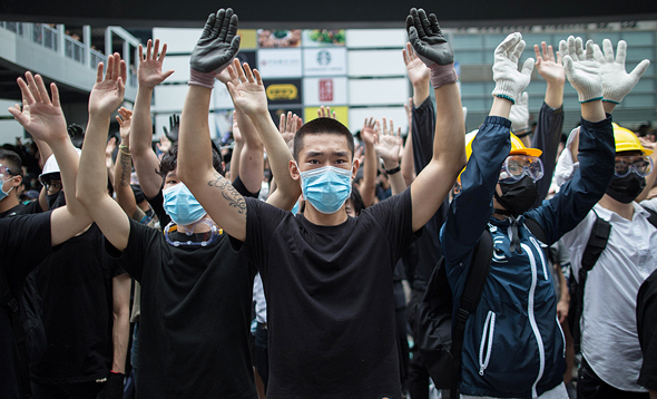 Protesters in Hong Kong covering their face to avoid facial recognition. Photo: EPA 