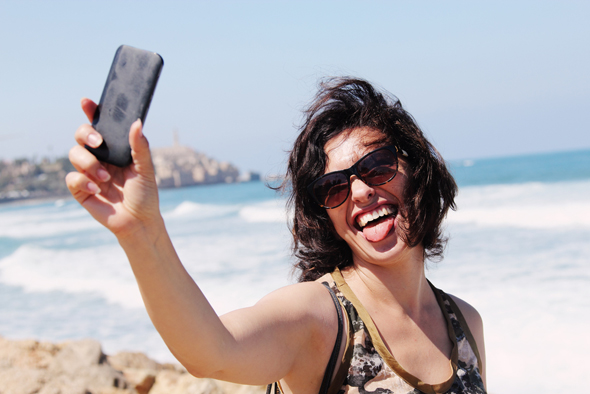 Taking a selfie at one of Tel Aviv's beaches. Photo: Shutterstock