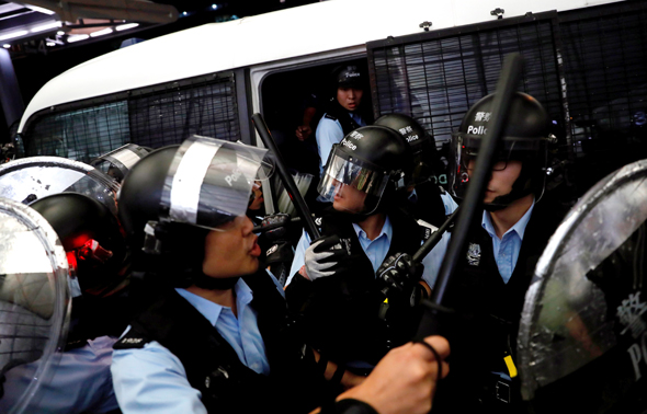 שוטרים מתעמתים עם מפגינים בשדה התעופה בהונג קונג