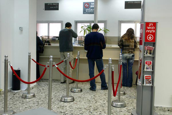 Customers visiting a bank. Photo: Shaul Golan