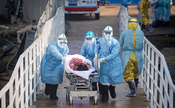 A coronavirus patient being led into hospital. Photo: AP