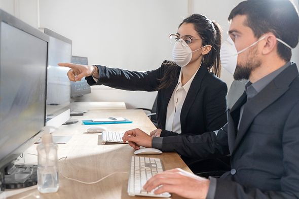 Office workers wearing masks. Photo: Shutterstock