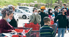 Shoppers line up outside a supermarket in March 2020. Photo: Amit Shabi