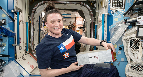 An astronaut at the ISS holding one of SpacePharma&#39;s miniature labs. Photo: NASA