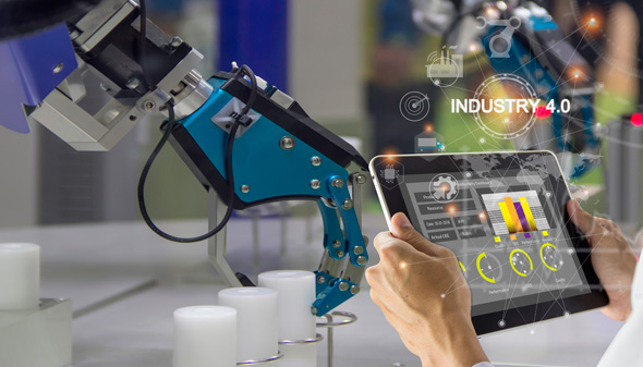 An operator controls a robot in a factory. Photo: Shutterstock