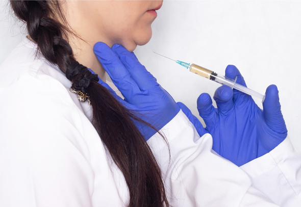 A doctor injects a compound into a patient