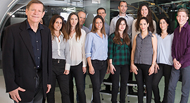 Infinidat founder Moshe Yanay (left) and company employees. Photo: Orel Cohen