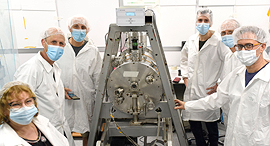 The R&D team stand in front of the nanosatellite. Photo: Tel Aviv University