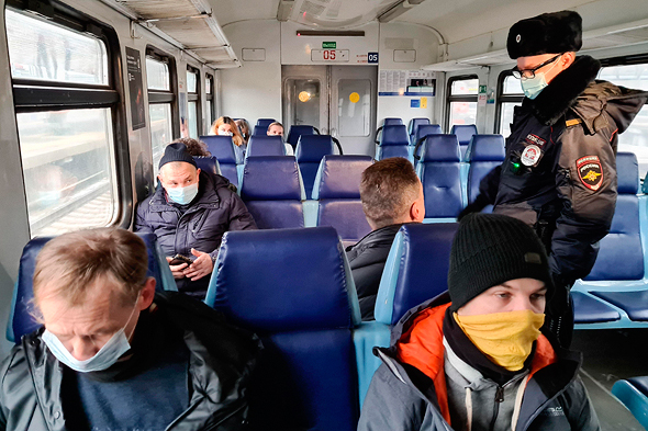 שוטר במוסקבה בודק עטיית מסיכות באוטובוס, צילום: איי פי