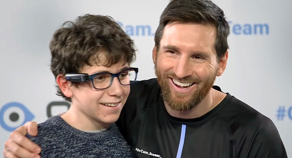 Lionel Messi gifts a boy the OrCam MyEye. Photo: OrCam