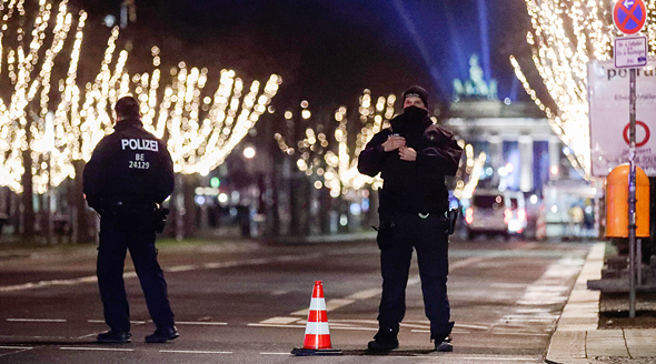 Police officers enforce the curfew in Berlin on new Year