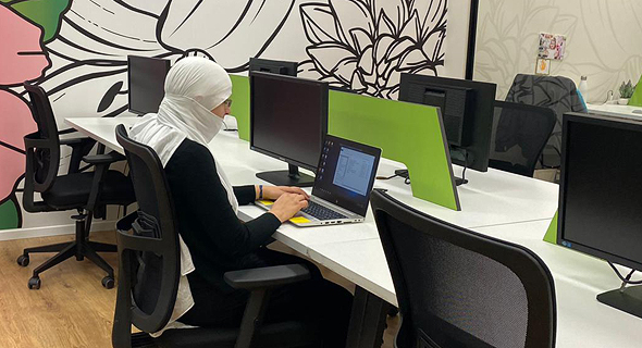 A female Druze programmer works in the Lotus hub&#39;s shared office space. Photo: Maysa Halabi Alsheikh