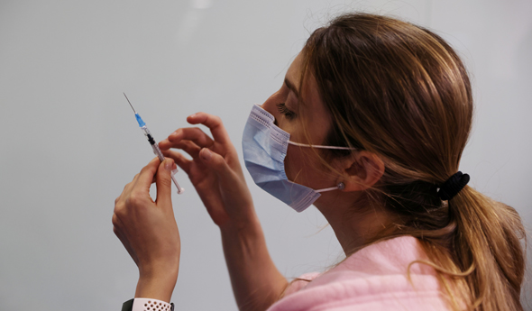 Teens will begin receiving the Covid-19 vaccine. A nurse administers a vaccine (pictured). Photo: Reuters