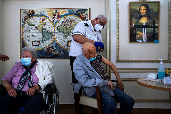 An elderly man being vaccinated for Covid-19. Photo: AP