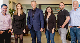 JVP chairman Erel Margalit (center) alongside the firm’s new partners. Photo: Dor Pazuelo