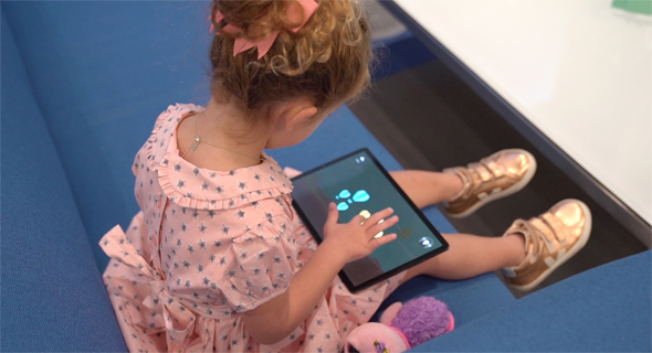 A girl plays the interactive GiantLeap game. Photo: Fusion LA