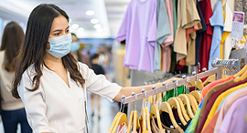 A woman in a store with clothing. Photo: Shutterstock