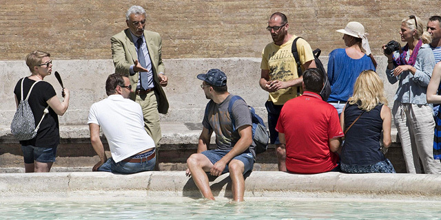 תיירים נכנסים למים שוחים מזרקה פונטנה די טרווי רומא