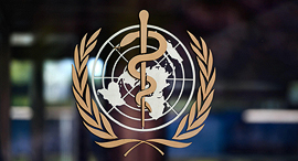 לוגו על דלת הכניסה של מטה ארגון הבריאות העולמי ב ג'נווה WHO