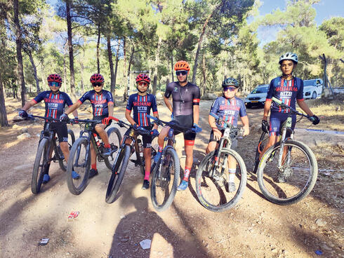 המאמן אחמד זידאן עם קבוצת רוכבי אופניים, צילום: בן מילקי