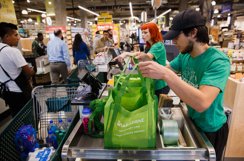 Instacart employees pack products at Whole Foods Los Angeles 