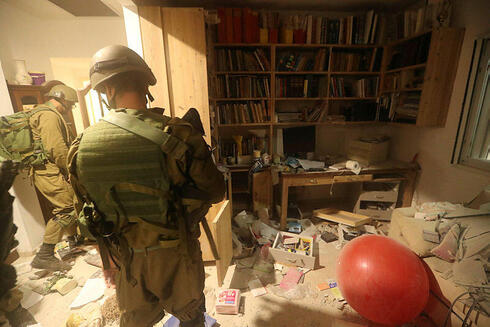 IDF soldiers in a home in Kibbutz Be'eri destroyed by Hamas terrorists. 