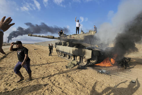 Terrorists burning an Israeli tank. 