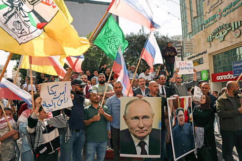 A pro-Hamas rally in Hebron with Russian flags and posters of Vladimir Putin and North Korean leader Kim Jong Un. 