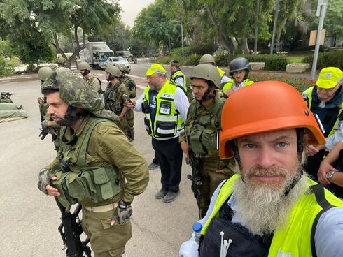 Josh Wander with ZAKA volunteers and military escort. 