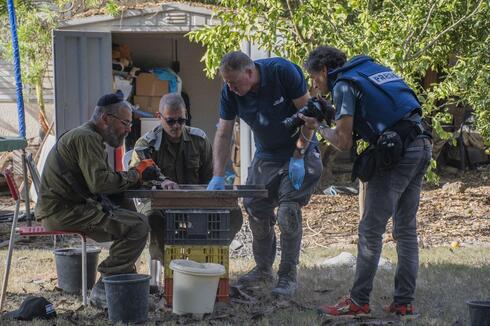 Archaeologists sifting through ash at Kibbutz Nir Oz. 