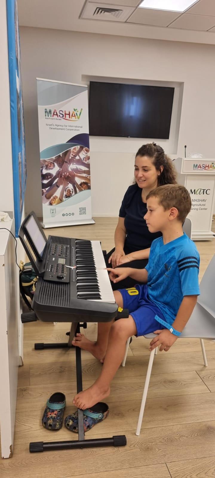 Adi Dagul teaches keyboards to the children of Kfar Aza