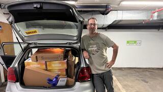 Simply team member David Davidov leads tools for evacuees