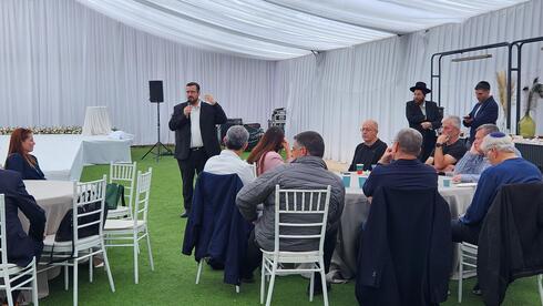 Moshe Friedman speaking at the event. 