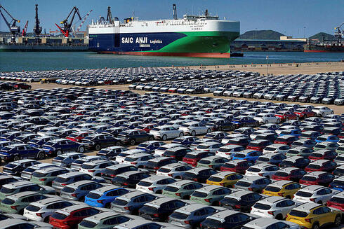 Chinese cars waiting to be loaded onto a ship in Yantai port 