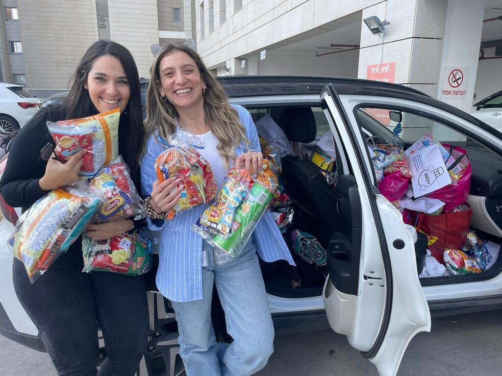 Moore Investment House employees and their children distribute rations to wounded soldiers